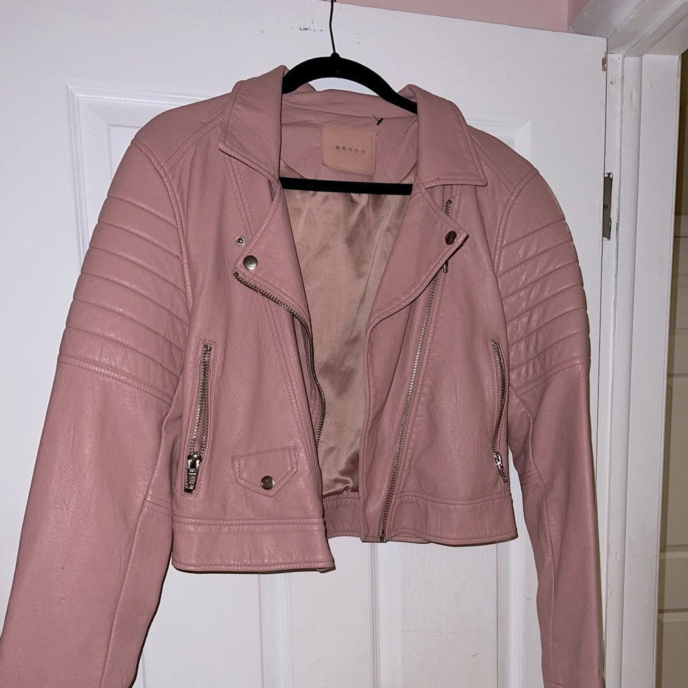 Pink leatherette jacket size large, zippers all work. Only worn a few times.